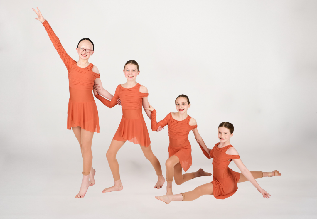 Four Dance Connections dancers in coordinated rust lyrical costumes